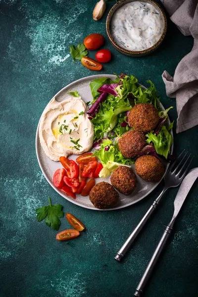 Humus, falafel ve sebzeli sağlıklı vejetaryen salatası.