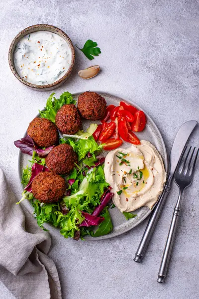 Humus, falafel ve sebzeli sağlıklı vejetaryen salatası.