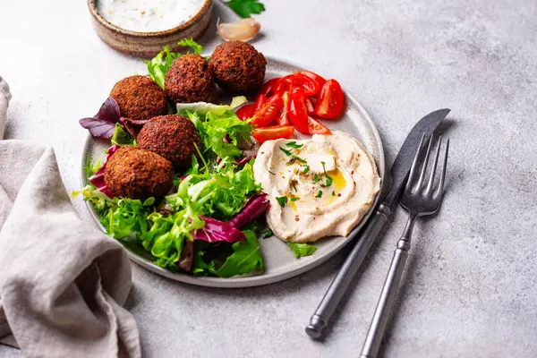 Humus, falafel ve sebzeli sağlıklı vejetaryen salatası.