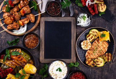 Çeşitli yaz ızgara bbq çeşitleri. Shashlik, ızgara sosis, sebze ve sos.