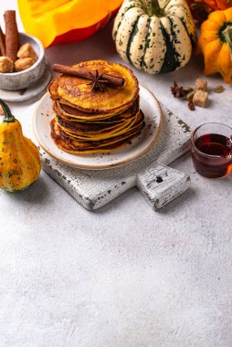 Pumpkin pancakes with maple syrup. Autumn food