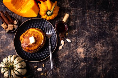 Pumpkin pancakes with maple syrup. Autumn food