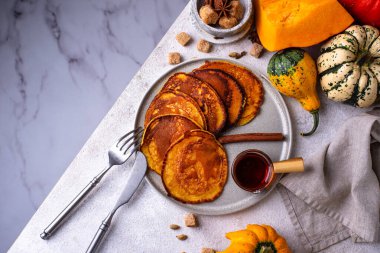 Pumpkin pancakes with maple syrup. Autumn food