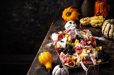 Halloween charcuterie board with cheese, salami and appetizers