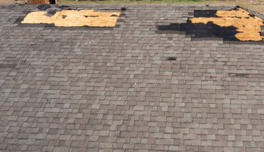 Roof with missing shingles, damaged by tornado during severe weather clipart