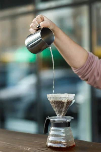 stock image Brewing coffee in a funnel. Pour over Coffee In Funnel. Alternative Method. Beautiful table with dark background. The process of brewing the coffee specialty. Coffee is pouring