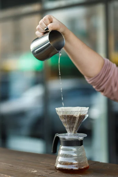 stock image Brewing coffee in a funnel. Pour over Coffee In Funnel. Alternative Method. Beautiful table with dark background. The process of brewing the coffee specialty. Coffee is pouring