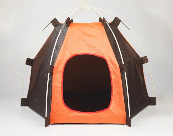 Front view of empty orange pet tent isolated on white background.