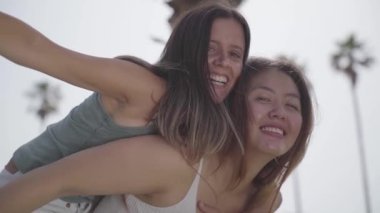 Friends riding on top of each other happily flying and celebrating joyfully smiling. High quality photo