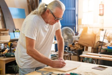 Marangoz atölyede ahşap mobilya üretiminde çalışıyor. Ustalık için profesyonel aletler. İş sanatı konsepti. Yüksek kalite fotoğraf