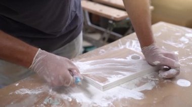 Kıdemli ressam, atölyede ahşap mobilyaları yavaş çekimde boyuyor. Yüksek kalite 4k görüntü