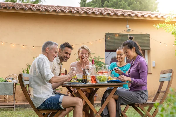 stock image Mature friends enjoying eating happy smiling and laughing during weekend. High quality photo