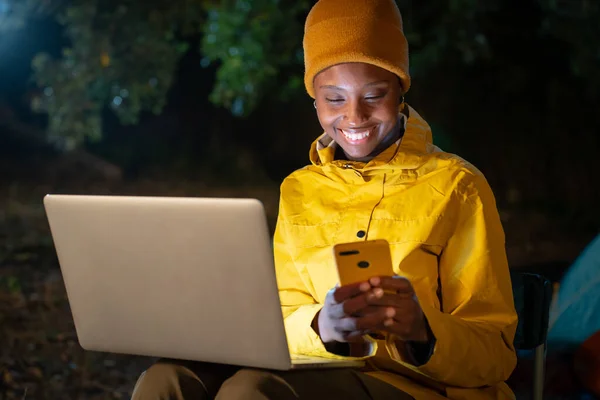A woman works remotely at a laptop at the nature in the evening. High quality photo