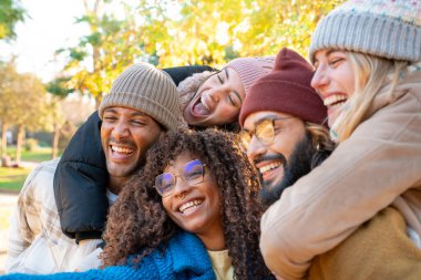 Cheerful group of friends taking smiling selfie. Happy people having fun together outdoors on vacation holidays. Concept of community, youth lifestyle and friendship. High quality photo
