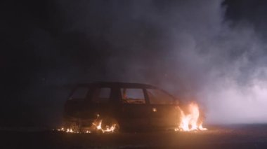 Burning car in the night with fog in slow motion. Car in flames. High quality 4k footage