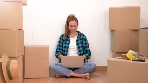 Portrait Young Happy Woman Sitting Floor Many Boxes Working Computer — Stock video