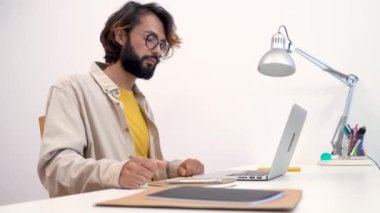 Young man finished project on computer lean stretching his back relaxing hands behind head. Stress relief muscle and joint pain concept. High quality 4k footage