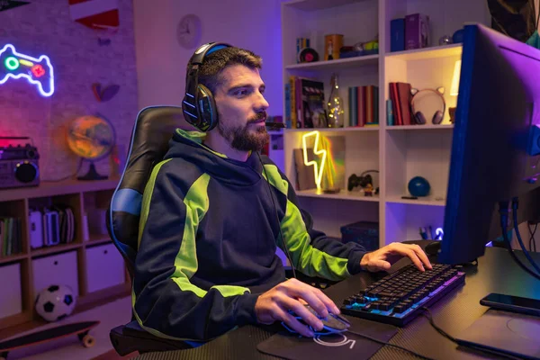 Gamer playing online video games championship online live stream. Caucasian player having fun with virtual e-sport gameplay tournament on computer. High quality photo