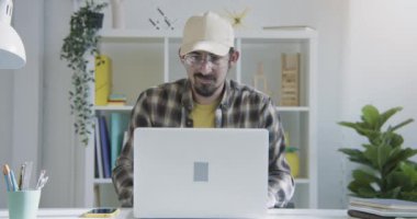 Young man working form home video call conference online chat with colleagues, interview or family. Distant communication concept. High quality 4k footage