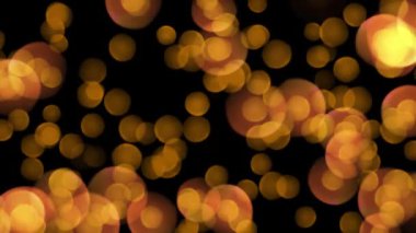 Yavaş Hareket Animasyonunda siyah zemin üzerinde altın parçacıklar. Parlak Noel ışıkları. Yüksek kalite 4k görüntü