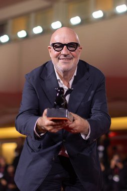 VENICE, ITALY - SEPTEMBER 06: Gianfranco Rosi poses during the winners photo-call at the 82nd Venice Film Festival on September 06, 2025 in Venice, Italy