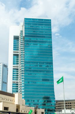Modern buildings in the city center of Riyadh with saudian flag in foreground, Al Olaya, Saudi Arabia clipart