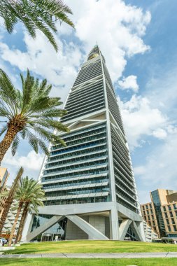 Modern buildings in the Al Olaya downtownt district with palms in the foreground, Al Riyadh, Saudi Arabia clipart