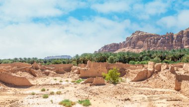 Al Ula ruined old town street with palms and rocks int the background, Saudi Arabia clipart