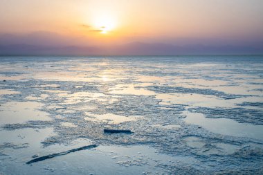 Etiyopya 'nın tuz gölü yüzeyinde gün batımı Danakil Depresyon Çölü, Afar Bölgesi, Etiyopya
