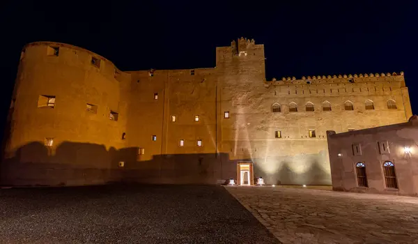 Stock image Jabreen citadel fortress stone walls and round bastion tower in night illumination, Bahla, sultanate Oman