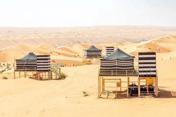 stock image Desert camping tents standing above the sands in the middle of Wahiba desert, Oman