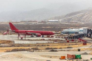 Big red plane parked after landing, Kangerlussuaq airport, Greenland clipart