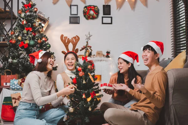 Group Happy Asian Friends Celebrating Christmas Decorate Christmas Tree Indoors Royalty Free Stock Photos