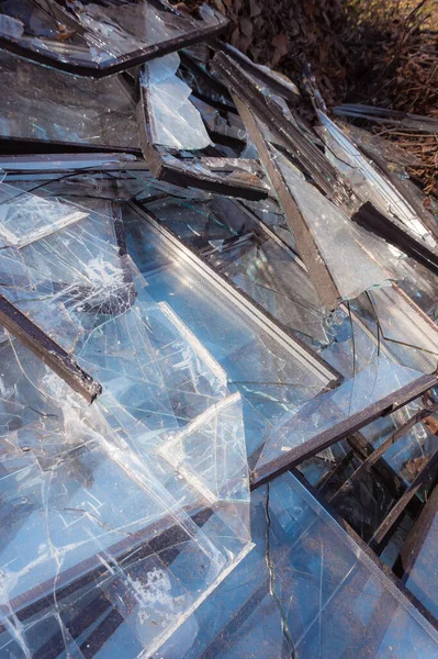 stock image Lots of broken glass. Broken windows of a high-rise building collected on a trash can. Consequences of a massive rocket attack. Consequences of military actions.