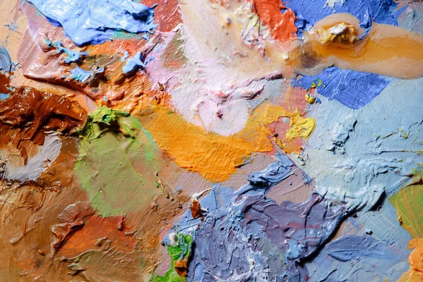 Colorful abstract texture. Smears of oil paint on an art palette. The concept of the modern school of art. Fragment of creative work. Colors of the year 2023