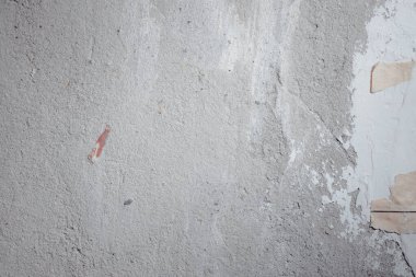 light concrete wall with cracks and scratches 