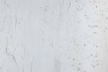 abstract texture of light concrete wall with cracks and scratches, background for copy space 