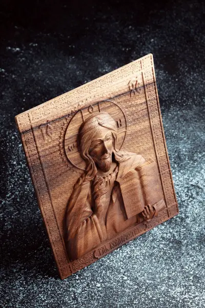 The Christian icon is made of solid wood by the milling method. Church equipment. Greeting card for the Ascension of Jesus Christ. Background for Christmas card.