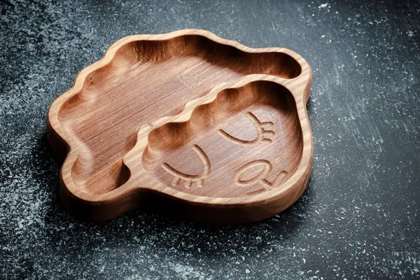 A plate for children in the shape of a lamb is made of wood for serving snacks, fruits, nuts, cheeses, meat and original serving of main dishes. Accessories for a modern kitchen.