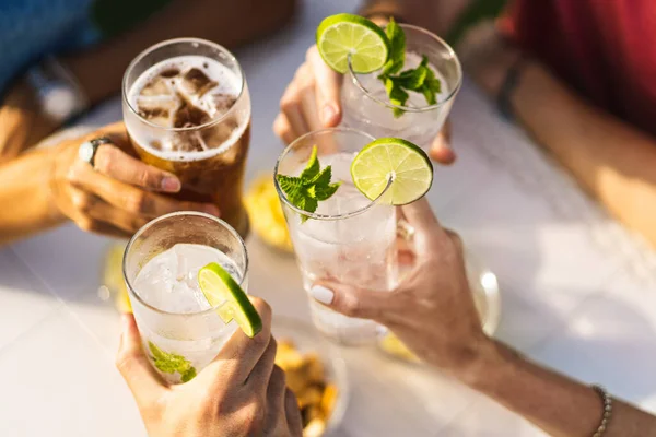 stock image Group of people celebrating toasting with cocktails - cropped detail with focus on hands - lifestyle concept of people, drinks and alcohol - no faces - unrecognizable people