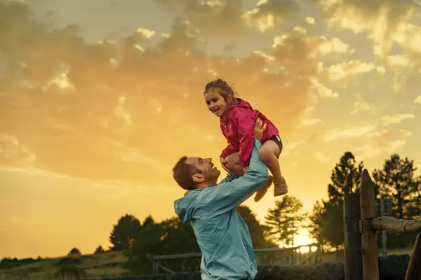 Sunset Wooded Area Father Joyfully Lifts His Year Old Daughter — Stock Photo, Image