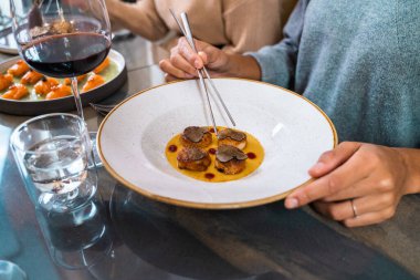 Lüks restoranda mantar soslu kurutulmuş istiridye ve kaliteli şarap, gurme meze tabağını kapat.