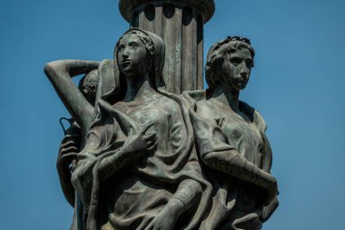 Catania, Italy - October 31, 2024 - The bronze sculpture on the candelabra in piazza Universit, Catania, illustrates the legend of Colapesce, a mythical figure said to hold up Sicily. Designed by Mim Maria Lazzaro in 1957, this artwork celebrates th clipart