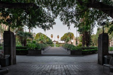 Giardino Bellini 'nin Katanya, Sicilya' daki girişi 1883 'te açıldı ve 1879' da her ikisi de kültürel dönüm noktası olarak halka açık alanlarda inşa edilmiş olan merkezi bir şelaleye ve Müzik Büfesi 'ne öncülük etti..