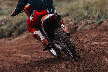 Motocross, pieces of dirt flying off the bike, off-road motorbike races, rear view