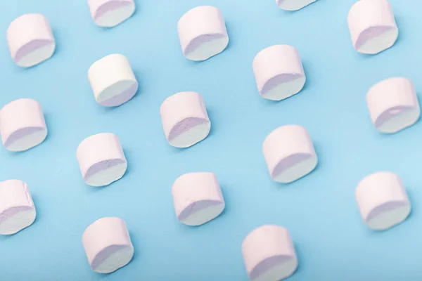 Sweet background with candy. Marshmallow on blue background