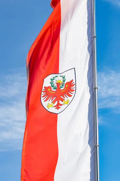 stock image Red and white colored Flag with shield bearing a red eagle; Flag of South Tyrol (Sdtirol, Alto Adige) officially named Autonomous Province of Bolzano in Northern Italy