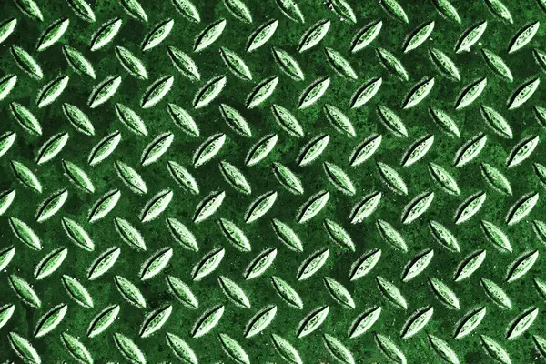 Yeşil endüstriyel metal dokusu. Işık yansımalı elmas plaka deseni. Güvenlik botu yüzeye yakın çekim. Çelik zemin arka planı. Ağır ekipman ayrıntıları. İmalat ya da depo arkaplanı.