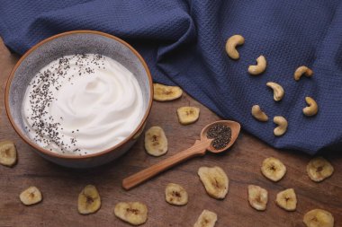 Bowl with Greek yogurt and fruit with nuts, seeds