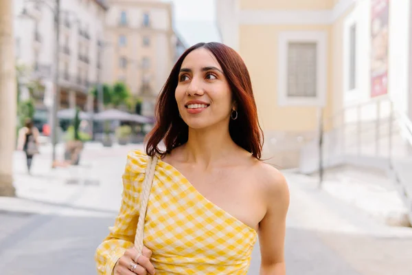 stock image Frontal portrait of a beauty woman in summer dress walking relaxed along the street